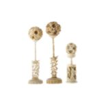 A LOT OF THREE EARLY 20TH CENTURY CHINESE IVORY CONCENTRIC BALLS WITH STANDS