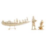 AN EARLY 20TH CENTURY INDIAN IVORY CARVING OF A BOAT AND TWO FIGURES