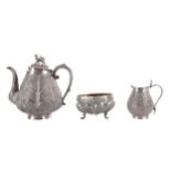 AN INDIAN WHITE METAL THREE PIECE TEA SERVICE