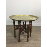 AN INDIAN BRASS TABLE ON FOLDING STAND