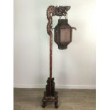 A CHINESE CARVED WOOD FLOOR STANDING LAMP