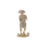 A JAPANESE IVORY CARVING OF A FISHERMAN