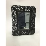 A CHINESE EBONY WALL MIRROR