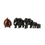 A LOT OF EBONISED ELEPHANTS AND A COCONUT SHELL CADDY