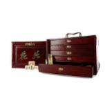 AN EARLY 20TH CENTURY CHINESE MAHJONG SET IN BRASS MOUNTED WOOD BOX