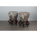 A PAIR OF 20TH CENTURY CHINESE FAMILLE ROSE FISH BOWLS WITH STANDS