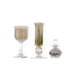 A CONTEMPORARY GLASS CANDLESTICK, ALONG WITH A WINE GLASS AND PERFUME BOTTLE