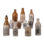 A COLLECTION OF ADVERTISING STONEWARE BOTTLES AND JARS