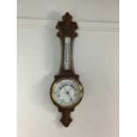 A VICTORIAN OAK WHEEL BAROMETER