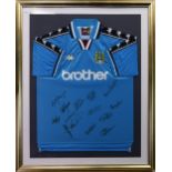 A SIGNED FRAMED MANCHESTER CITY F.C. JERSEY