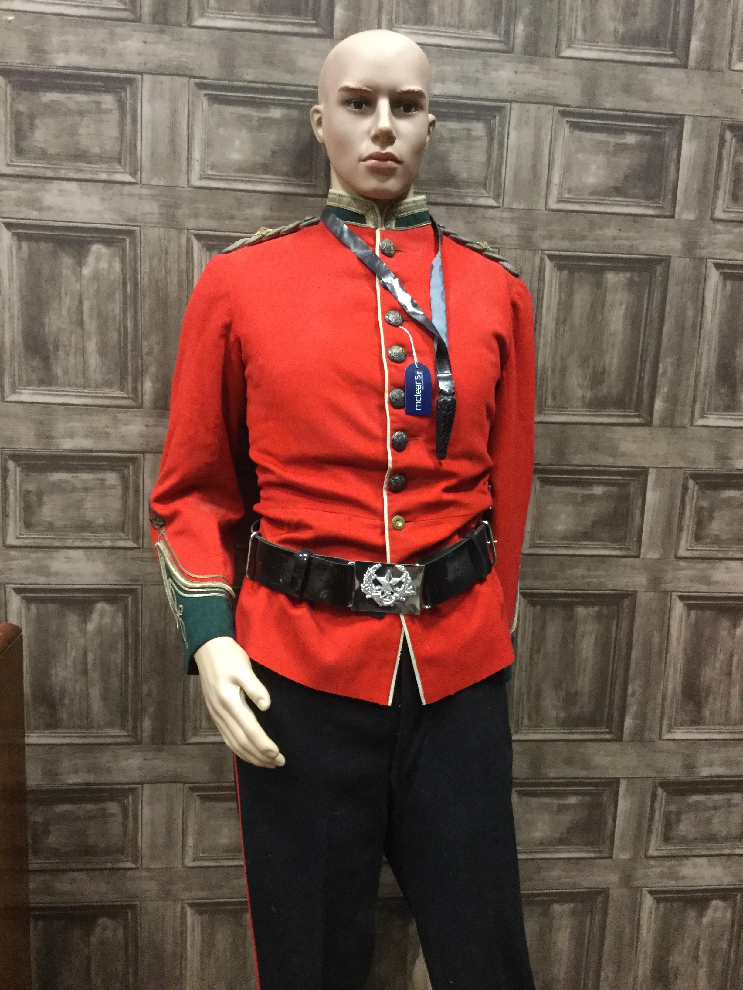 A MODERN MANNEQUIN IN MILITARY DRESS AND ANOTHER