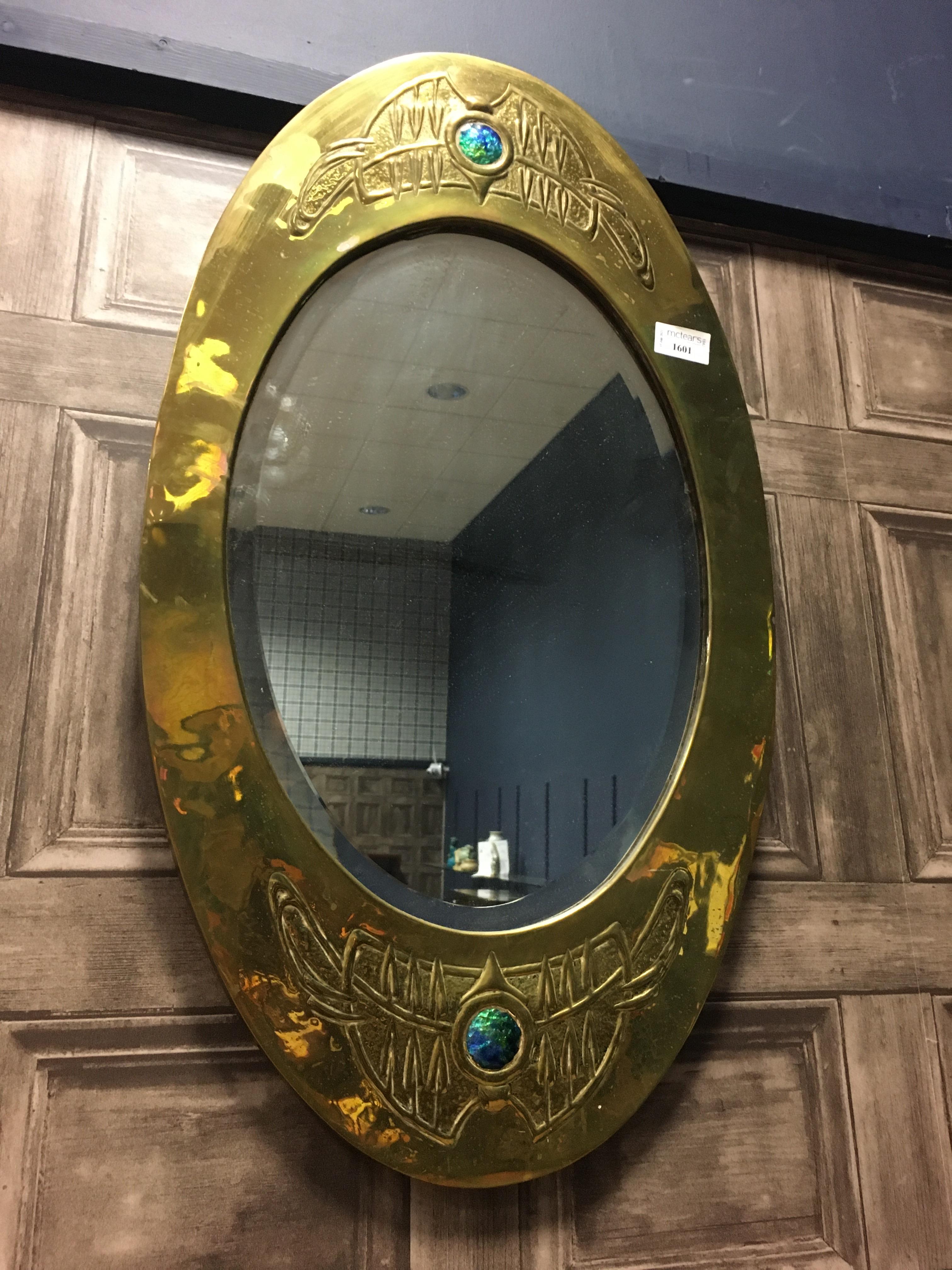 AN ARTS & CRAFTS BRASS AND ENAMEL MARQUISE SHAPED WALL MIRROR