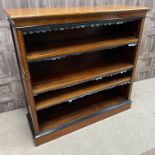 A LATE VICTORIAN MAHOGANY AND EBONISED OPEN BOOKCASE