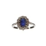 A BLUE GEM SET AND DIAMOND CLUSTER RING