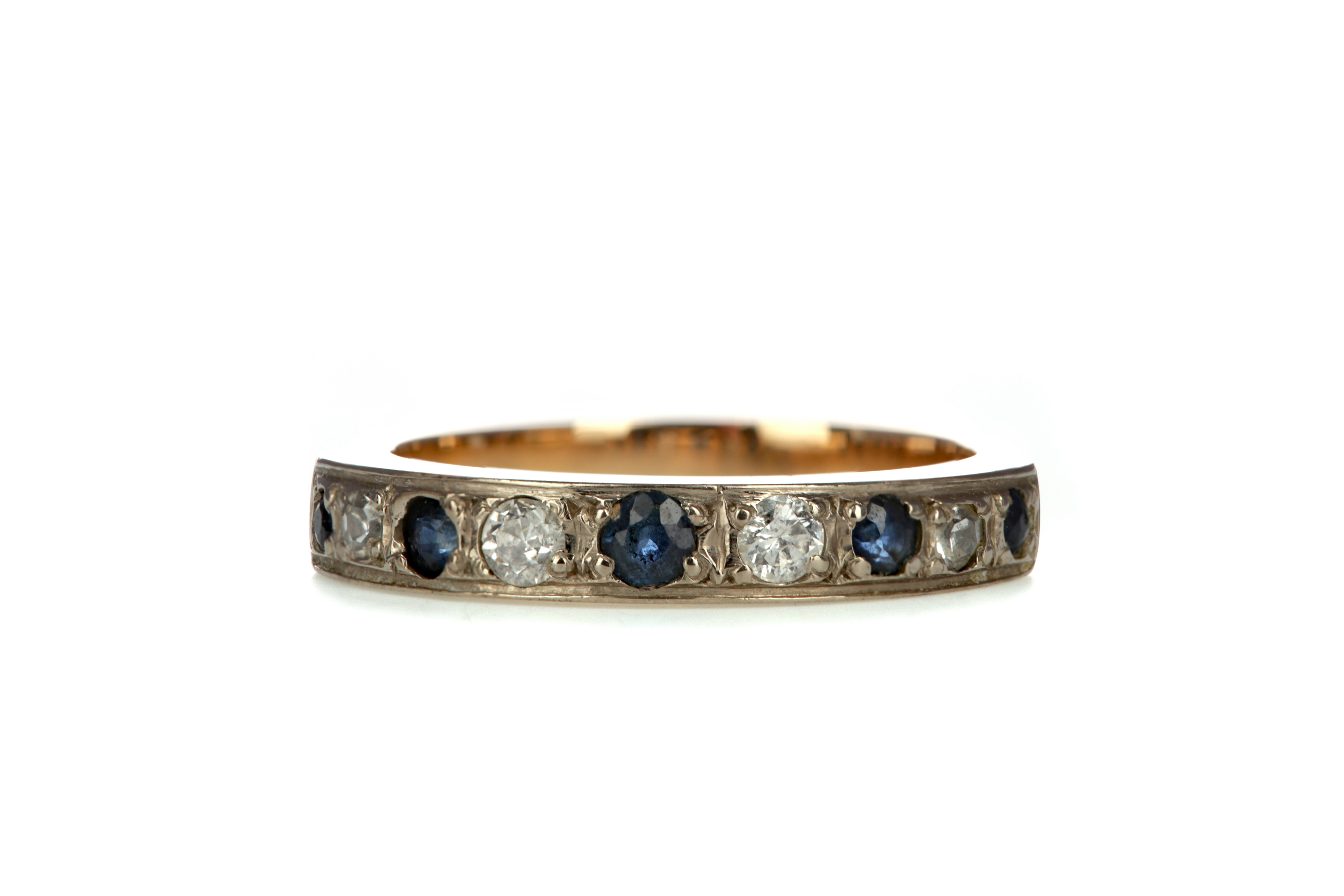 A BLUE GEM SET AND DIAMOND HALF ETERNITY RING