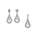 A DIAMOND PENDANT AND EARRING SET