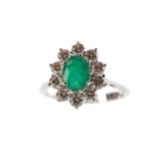 AN EMERALD AND DIAMOND CLUSTER RING