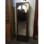 AN EDWARDIAN MAHOGANY WARDROBE SECTION