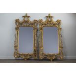 A PAIR OF GILT UPRIGHT WALL MIRRORS OF CHIPPENDALE DESIGN