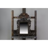AN EARLY 20TH CENTURY BLACK FOREST WALL MIRROR