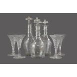 A COLLECTION OF FOUR LATE VICTORIAN GLASS DECANTERS, ALONG WITH FOUR WINE GLASSES