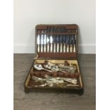 AN OAK CANTEEN OF SILVER PLATED CUTLERY