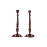 A PAIR OF GEORGE III STYLE MAHOGANY CANDLESTICKS