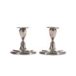 A PAIR OF EDWARDIAN SILVER DWARF CANDLESTICKS