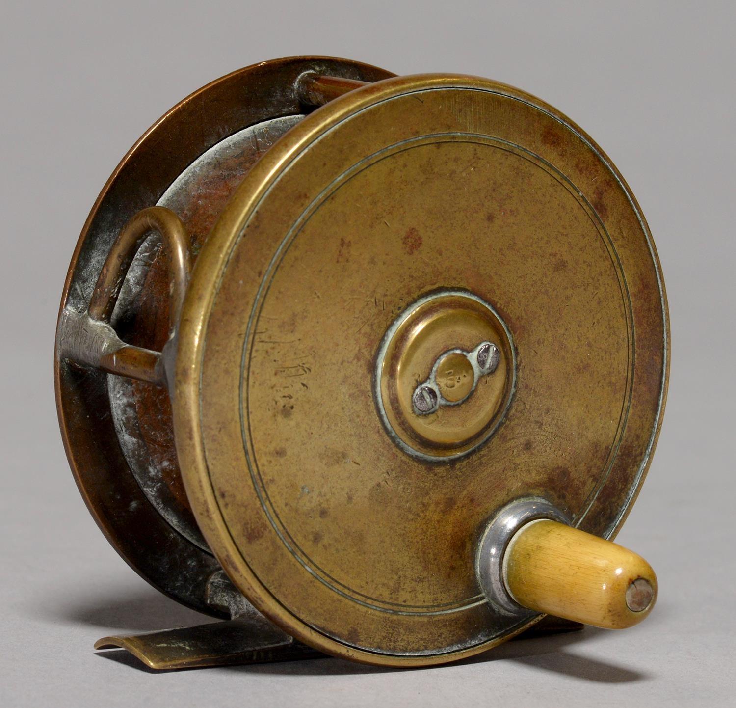 ANGLING. A VICTORIAN BRASS 3" FISHING REEL, UNMARKED AND A CUT GLASS BRASS MOUNTED INKWELL, AN