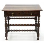 A WILLIAM III OAK SIDE TABLE, THE DRAWER CARVED WITH LUNETTES, BRASS HANDLES, ON BOBBIN TURNED