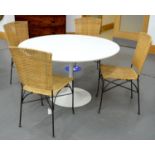 A 1960'S WHITE LAMINATE KITCHEN TABLE, THE ROUND TOP ON CAST AND PAINTED ALLOY CENTRAL FLARED
