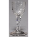 A WINE GLASS, 19TH C, THE FACETED OGEE BOWL WITH  JACOBITE ENGRAVING ON FACETED STEM AND SPREADING