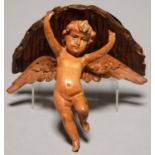 A CONTINENTAL CARVED LIMEWOOD WALL BRACKET IN THE FORM OF A CHERUB, LATE 19TH C, SUPPORTING A RUSTIC