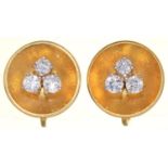 A PAIR OF DIAMOND EARRINGS, C1960, THE THREE ROUND BRILLIANT CUT DIAMONDS BEFORE CONCAVE GOLD