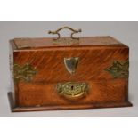 A VICTORIAN BRASS MOUNTED OAK SMOKER'S COMPENDIUM, C1890, THE SLIDING LID OPENING BY ACTION OF THE