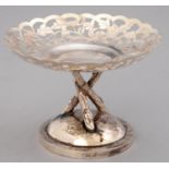 A CHINESE PIERCED AND ENGRAVED SILVER BONBON STAND, EARLY 20TH C, ON THREE RUSTIC LEGS AND DOMED