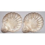 A PAIR OF VICTORIAN SHELL SHAPED DIE STAMPED AND PIERCED SILVER FRUIT DISHES WITH CRIMPED RIM, ON