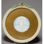 A JASPER TYPE PLAQUE OF A SEMI-NAKED YOUNG WOMAN IN DIAPHANOUS DRAPERY ON CLOUDS, 20TH C, 15.5CM