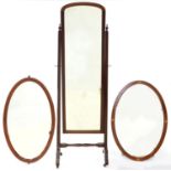 A MAHOGANY CHEVAL MIRROR, C1930, WITH BEVELLED PLATE, ON BRASS CASTORS, 168CM H X 51CM W AND TWO