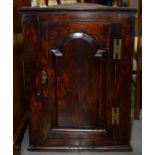 A GEORGE III ELM HANGING CORNER CUPBOARD, C1780, FITTED WITH TWO SHELVES ENCLOSED BY A DOOR WITH