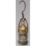 AN EARLY ELECTRIC BRASS AND STEEL MINER'S SAFETY LAMP, SECOND QUARTER 20TH C, 29CM H EXCLUDING HOOP,