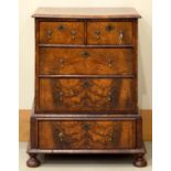 A WALNUT CHEST ON STAND, 19TH/EARLY 20TH C, THE QUARTER VENEERED TOP WITH OVOLO LIP ABOVE TWO
