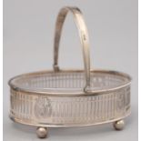 A GEORGE V PIERCED SILVER BUTTER DISH WITH SWING HANDLE AND FROSTED GLASS LINER, 10.5CM L, BY PARKER