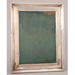 A SILVER PHOTOGRAPH FRAME WITH MOULDED BORDER,  BACKED ON VARNISHED WOOD, 24 X 19CM, MARKED 925