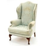 A WING ARMCHAIR, EARLY 20TH C, IN GEORGE II STYLE, UPHOLSTERED IN CLOSE NAILED PALE GREEN BROCADE,