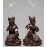 A PAIR OF SWISS CARVED LIMEWOOD VASES IN THE FORM OF A FOX AND TREE, C1900, ON ROCKY MOUND,