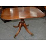 AN EARLY VICTORIAN MAHOGANY BREAKFAST TABLE, THE TIP-UP OBLONG TOP ON BULBOUS PILLAR AND QUADRUPLE