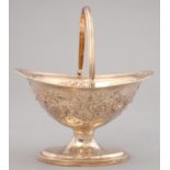 A GEORGE III SILVER SUGAR BASKET WITH REEDED HANDLE AND RIMS, LATER CHASED WITH FESTOONS, 17CM H, BY