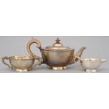 A GEORGE V SILVER TEA SERVICE WITH APPLIED FOLIATE BORDER, TEAPOT 13.5CM H, BY WILLIAM NEALE