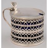 A GEORGE V PIERCED SILVER MUSTARD POT WITH BEADED RIM, BLUE GLASS LINER, 73MM H, BY C SHAPLAND AND